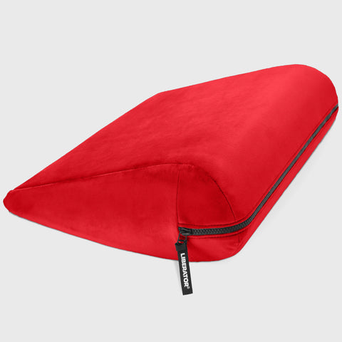 Red travel pillow with a brand tag on a light gray background
