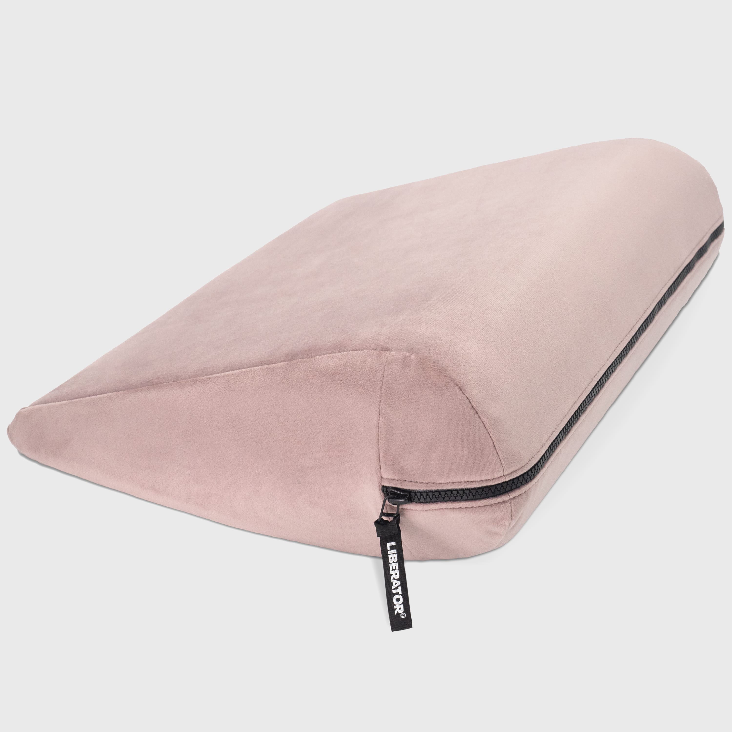 Pink travel pillow with a zipper on a light gray background