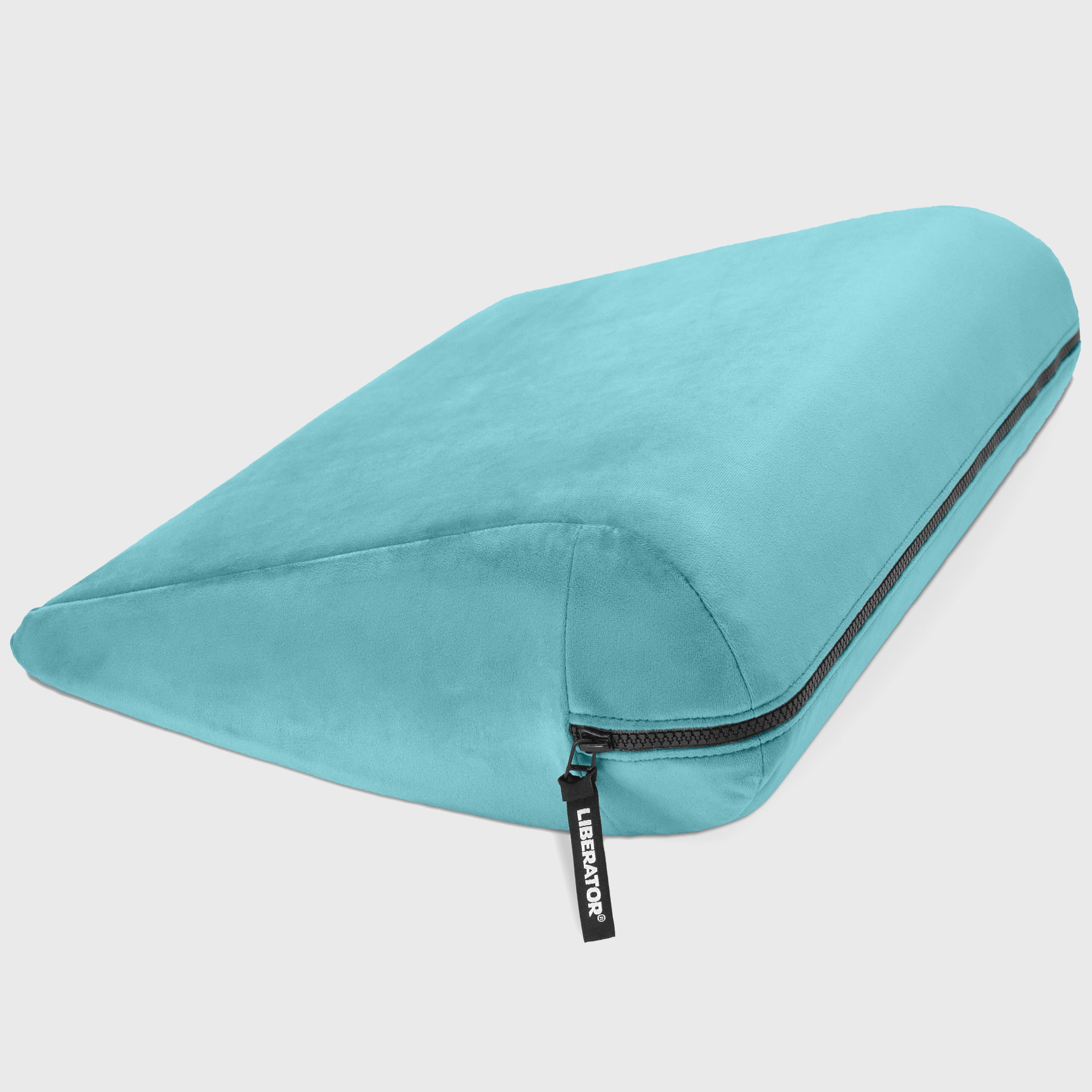 Turquoise travel pillow with a zipper on a light gray background