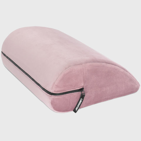 Pink travel pillow with a brand logo on a light gray background