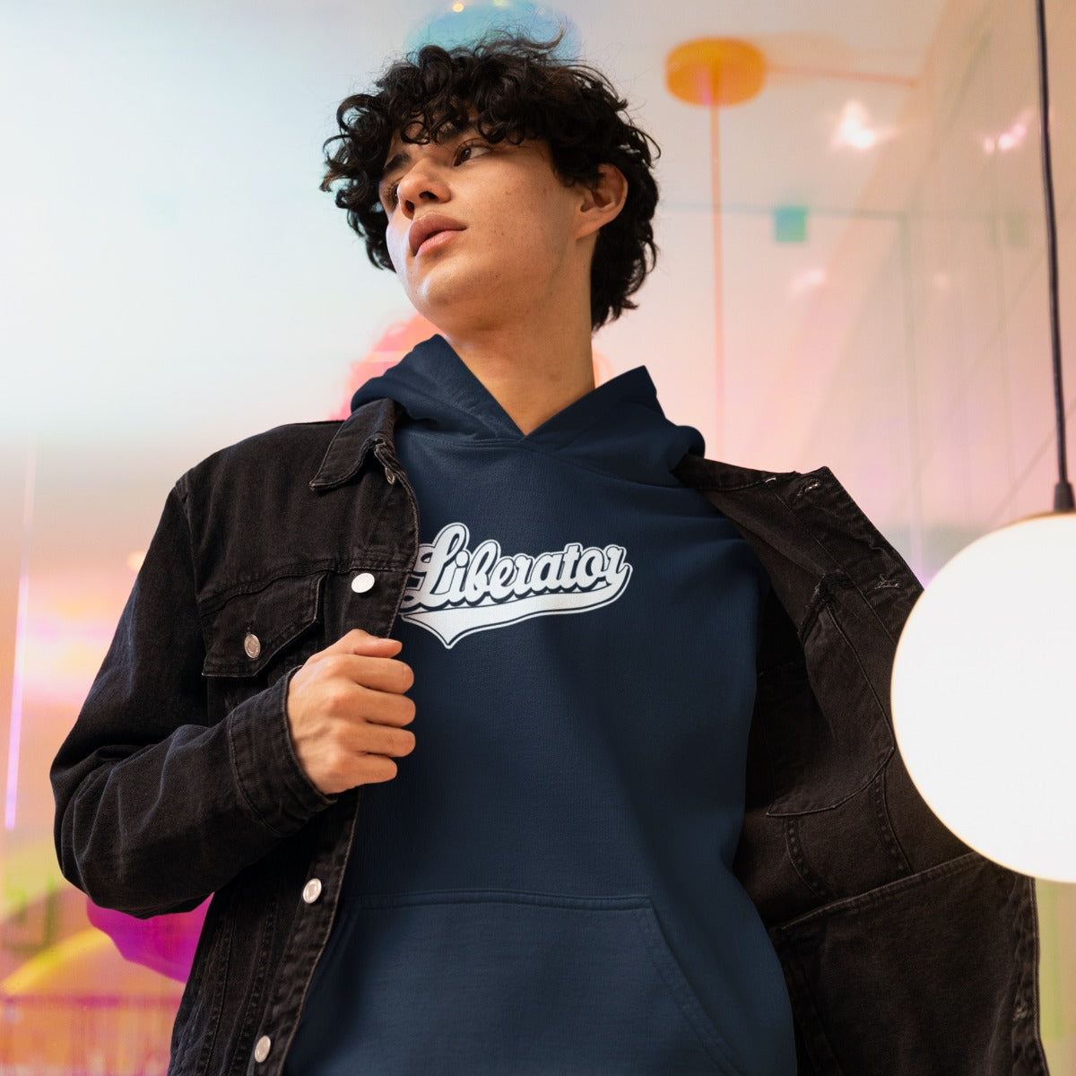 Man wearing the Liberator Baseball Logo Hoodie, navy blue