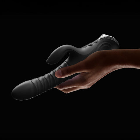 Lifestyle of person holding black Mose 2 thrusting rabbit vibrator by Zalo