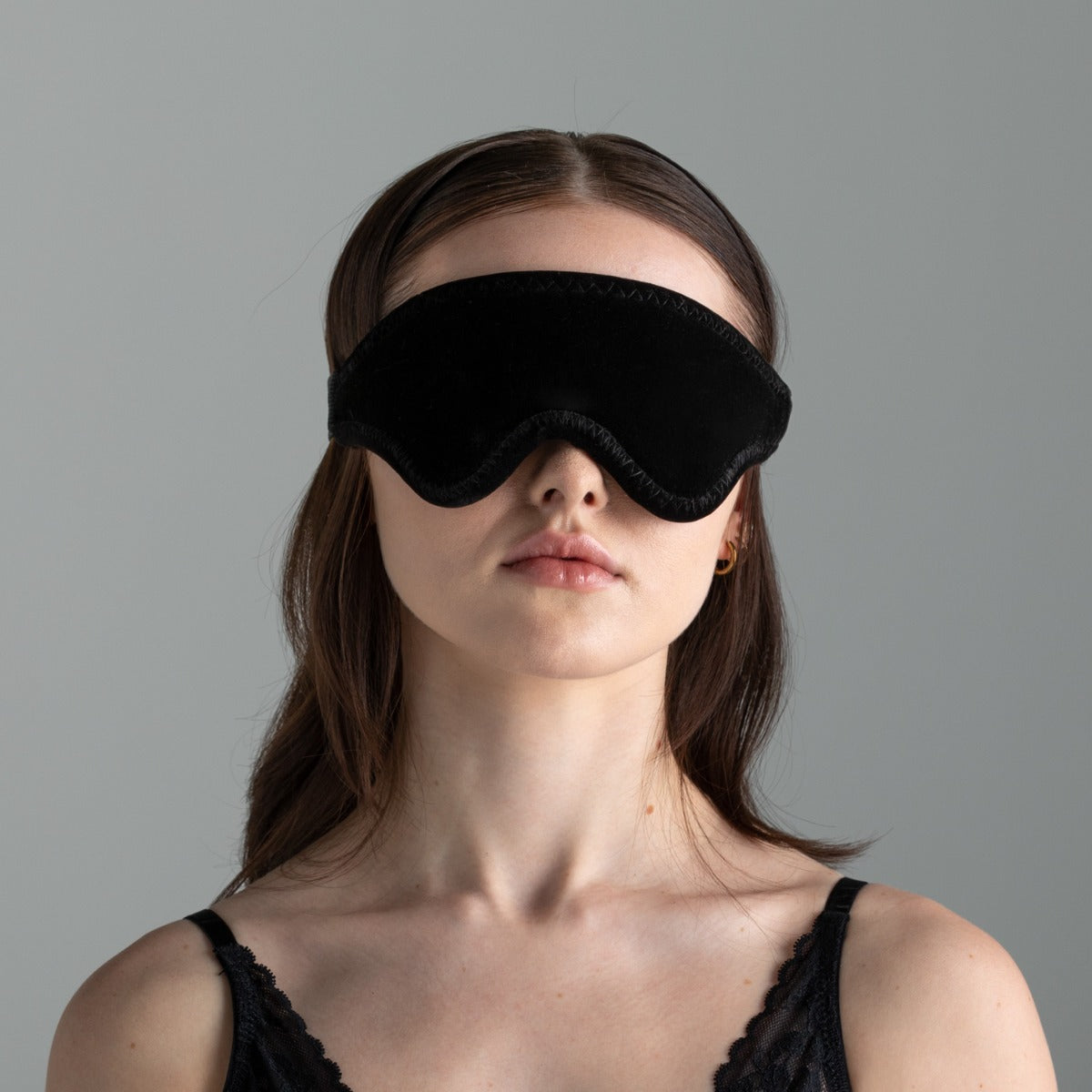 Woman wearing the LoveBlind No-Peek Adjustable Blindfold, black