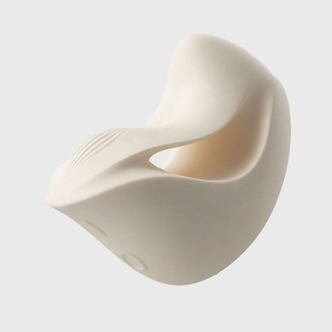 White ceramic heart-shaped vibrator on a light gray background