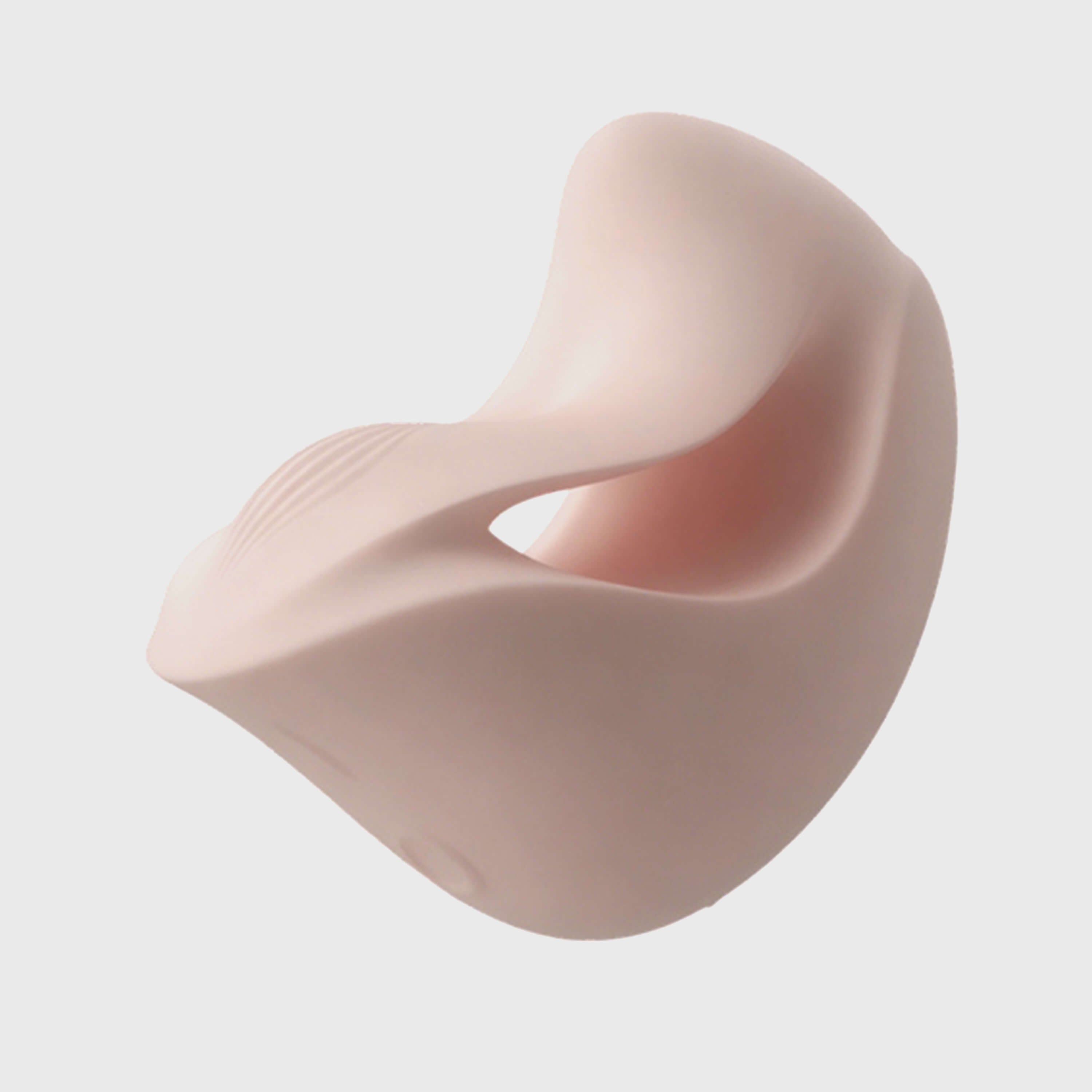 Pink silicone breast form on a light gray background