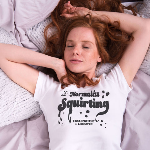 Woman on bed wearing Liberator T-Shirt