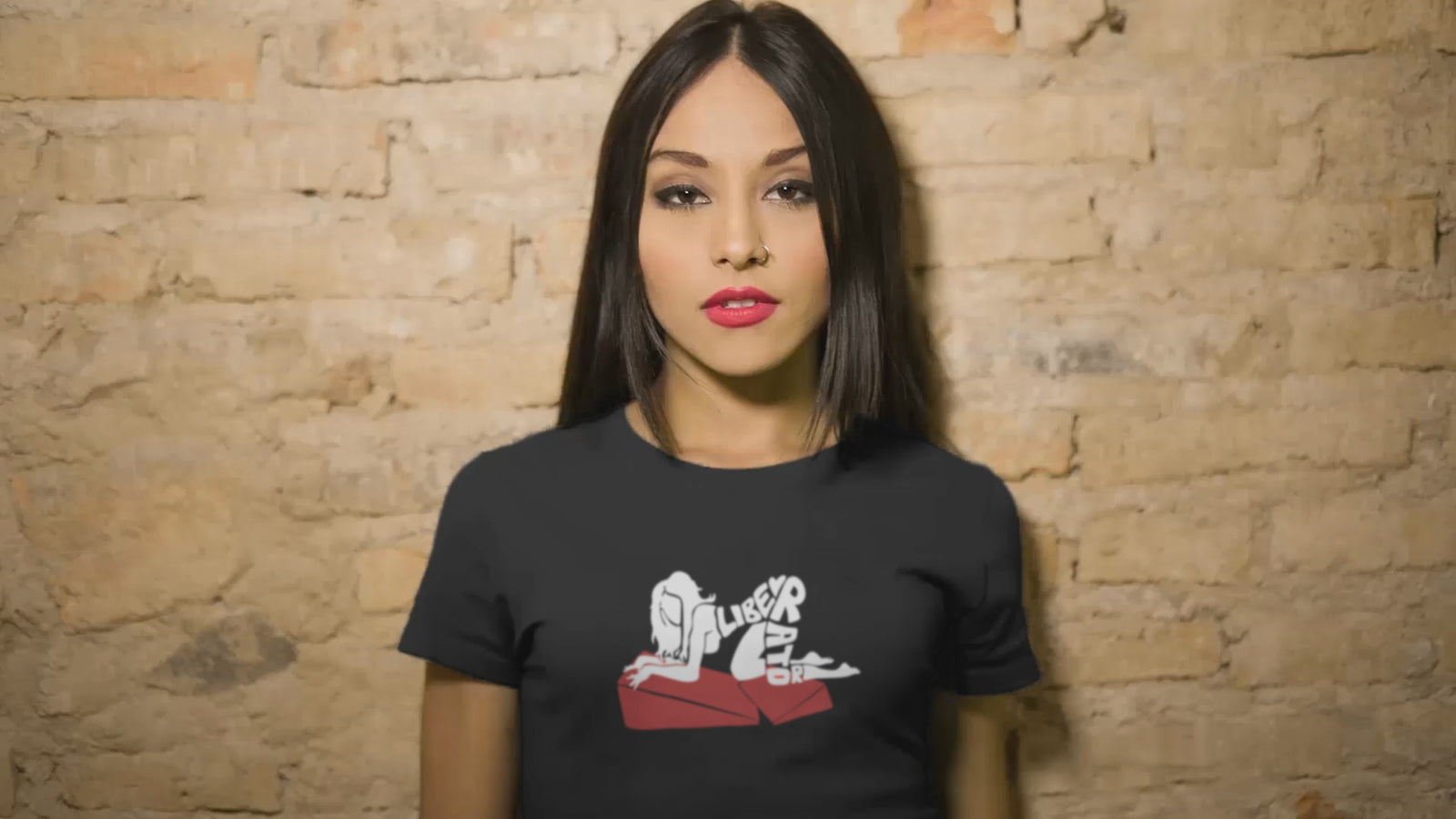 Video of woman in Liberator T-shirt in various poses on bed