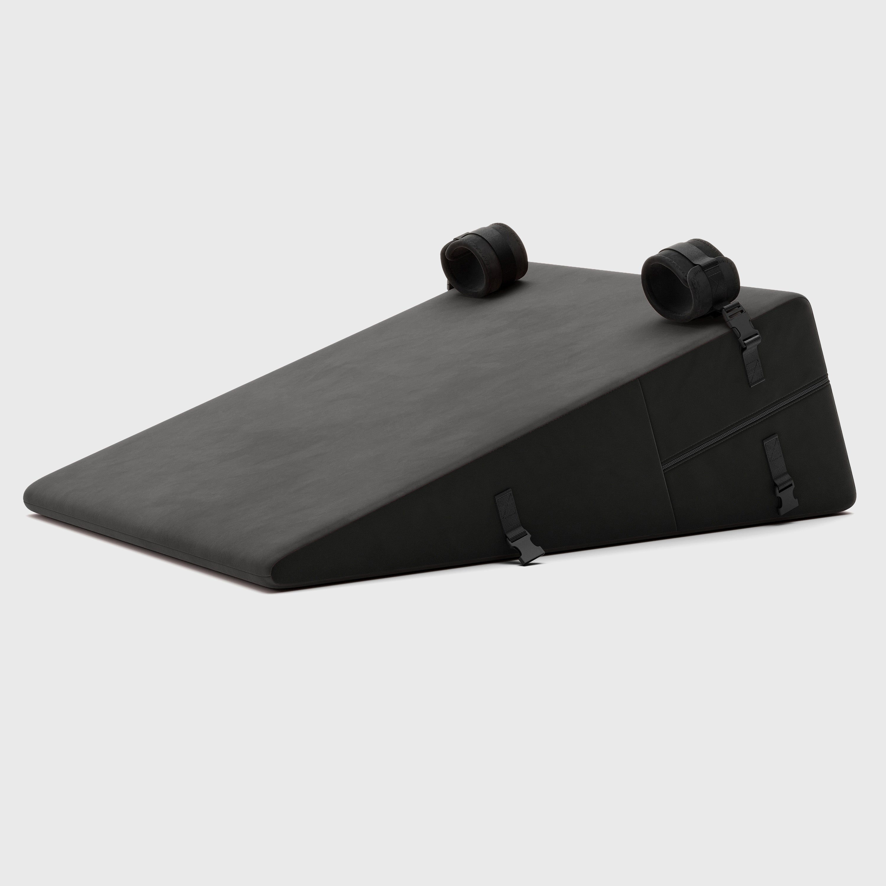 Black wedge-shaped product with two plush cuffs on a white background