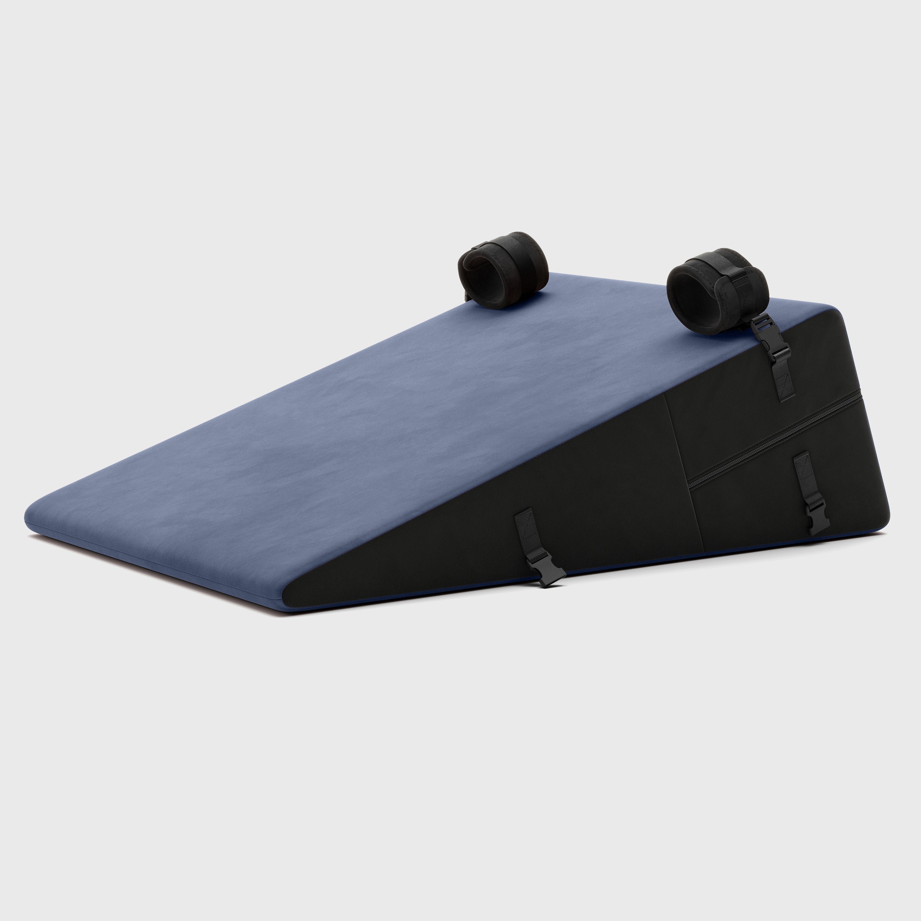 Blue ramp pillow with black straps on a light gray background
