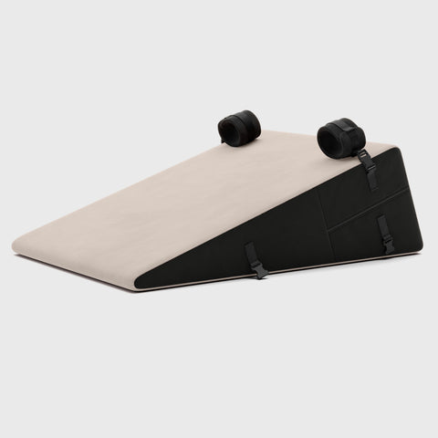 Beige and black wedge-shaped product on a light gray background