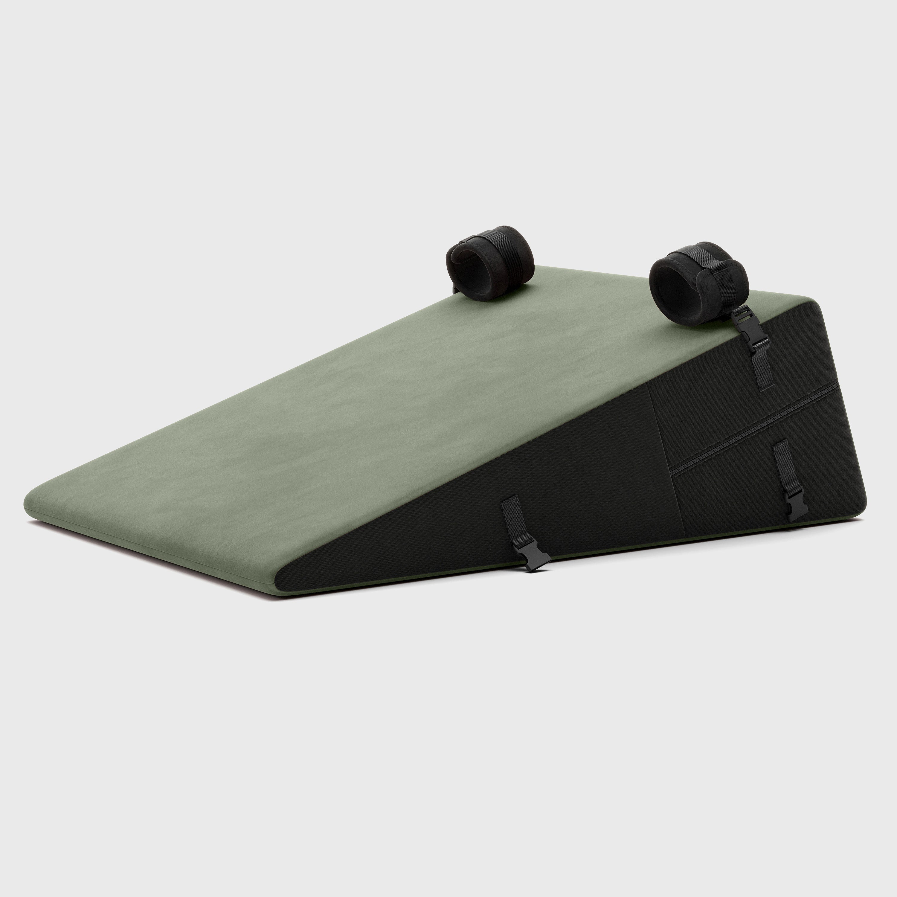 Green wedge-shaped product with black wheels on a light gray background