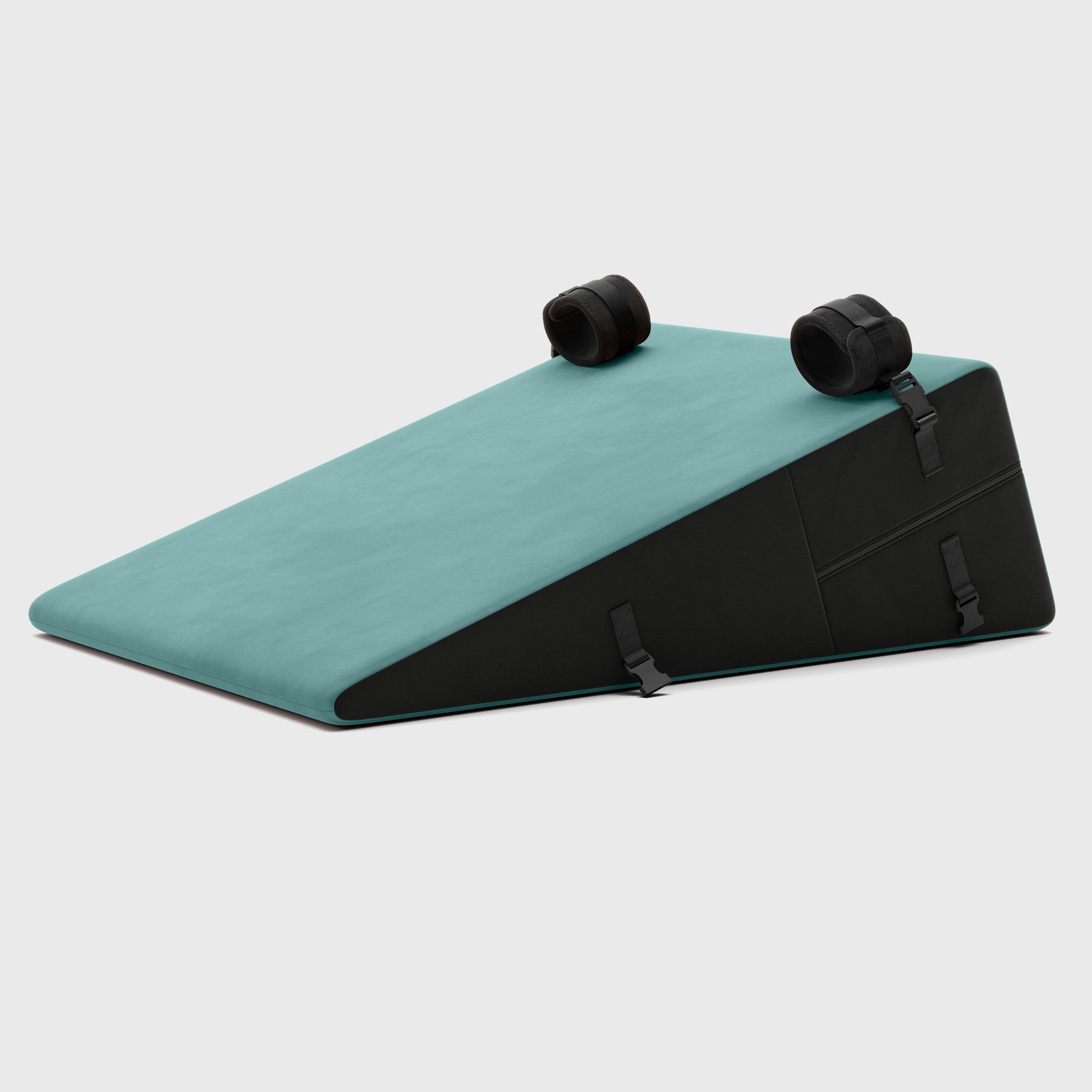 Teal and black wedge-shaped product on a light gray background