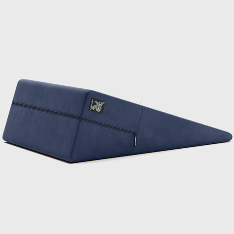 Navy ramp pillow with a brand logo on a light gray background