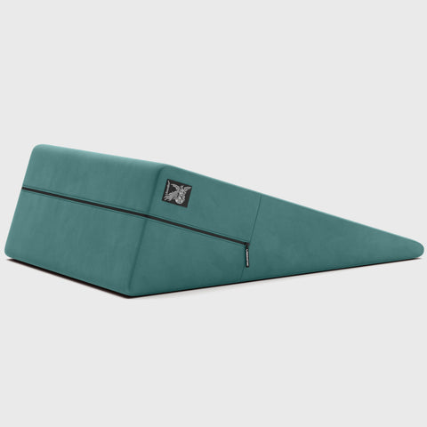 Teal ramp pillow with a brand logo on a light gray background