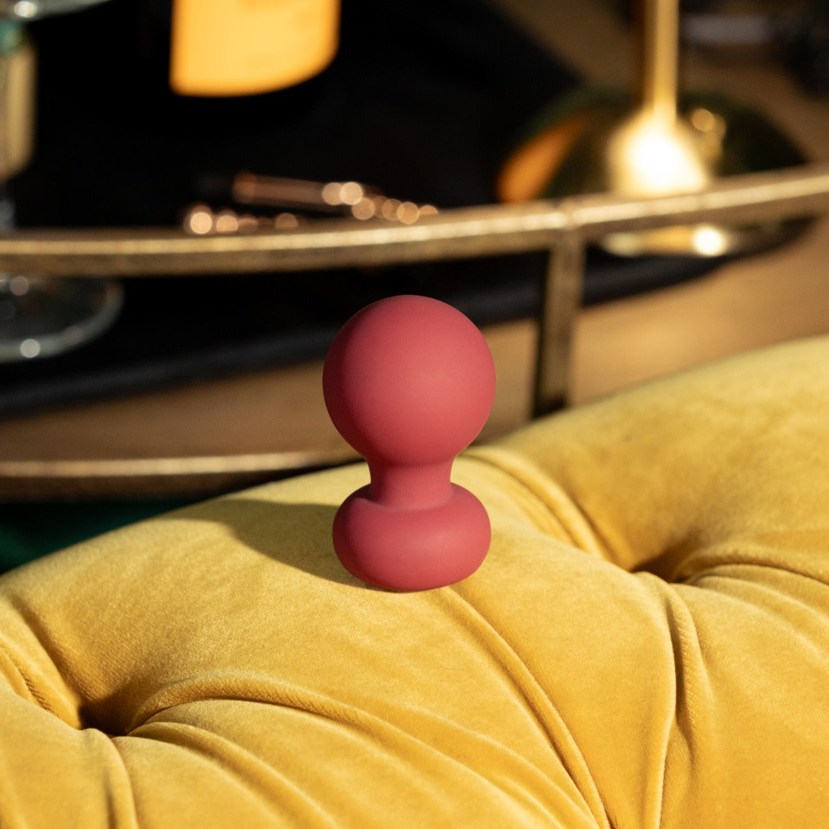 Lifestyle of Palm vibrator on the back of a vintage yellow couch