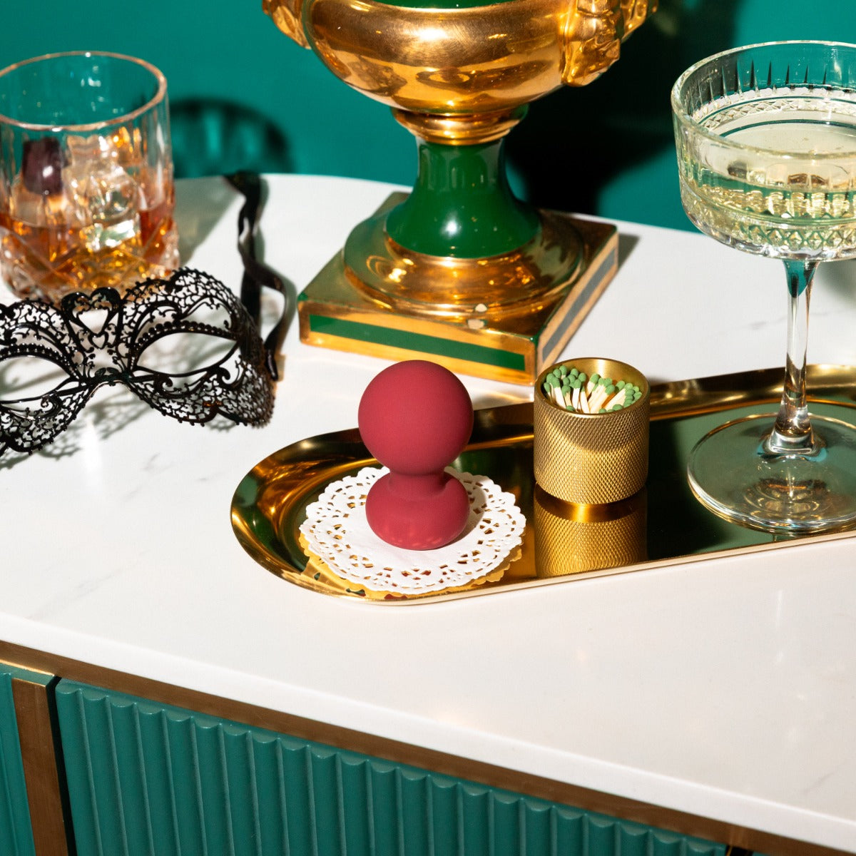 Lifestyle of Palm vibrator on a table with cocktails and masks