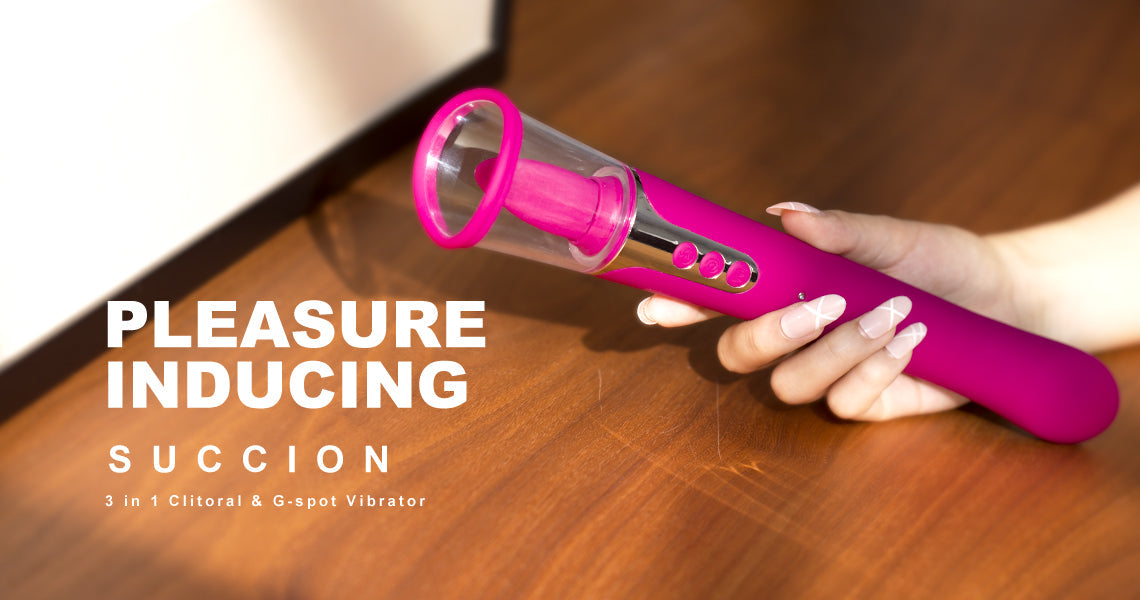 Pink and clear cylindrical vibrator held by a hand on a wooden surface with text 'Pleasure Inducing Suction' and product details.