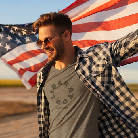 Man wearing the Liberator Freedom T-Shirt with the American Flag behind him.