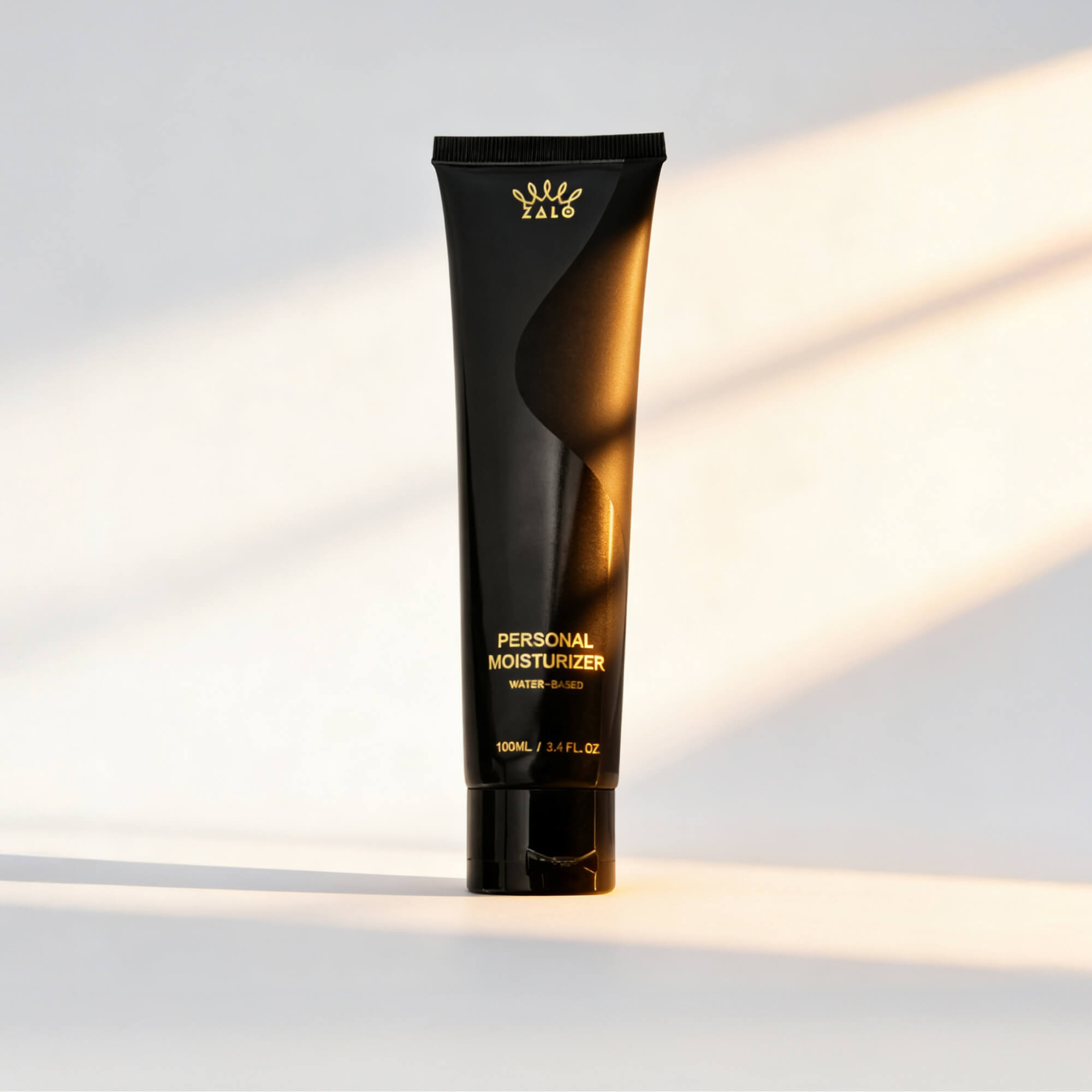 Black tube of personal moisturizer with gold text on a gradient background