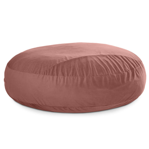 Round pink bean bag chair on a white background