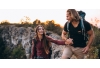 man holding woman's hand on outdoor hike