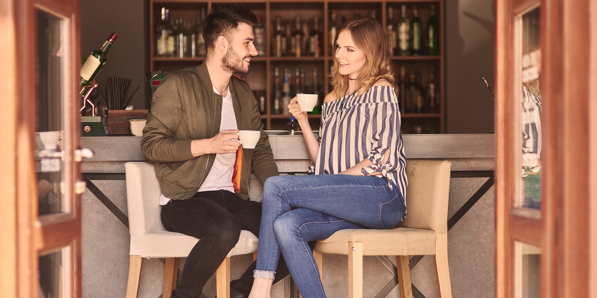 Couple at a cafe bar flirting